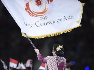Indonesia National Olympic Committee president Rita Subowo waves the Olympic Council of Asia (OCA) flag during the official handover to Indonesia during the closing ceremony of the 2014 Asian Games at The Incheon Asiad Main Stadium in Incheon on October 4, 2014. Indonesia will host the 2018 Asian Games. AFP PHOTO / MARTIN BUREAU (Photo by MARTIN BUREAU / AFP)