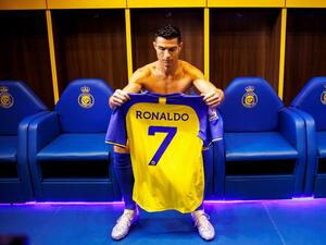 A handout picture released by Saudi Arabia's al-Nassr football club shows Al-Nassr's new Portuguese forward Cristiano Ronaldo holding the club's number seven jersey ahead of his unveiling ceremony at the Mrsool Park Stadium in the Saudi capital Riyadh on January 3, 2023. (Photo by Jorge Ferrari / Al Nassr Football Club / AFP)