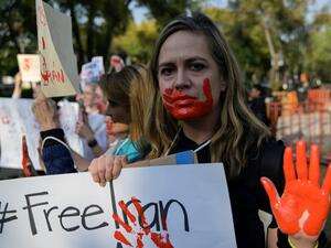 People take part in a protest against the execution of Iranian footballer Amir Nasr-Azadani -sentenced to death within protests following the death of Mahsa Amini. (Photo by Pedro PARDO / AFP) Mahsa Amini