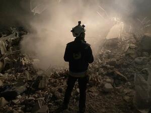 Graphic content / A member of the White Helmets civil defence rescue team stands in front of the rubble of a building during the search for survivors in the rebel-held Syrian town of Jindayris on February 8, 2023. (Photo by AFP) aid to Syria