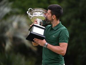 Serbia's Novak Djokovic poses with the Norman Brookes Challenge Cup trophy in Melbourne on January 30, 2023, after winning the Australian Open tennis tournament's mens' singles final against Greece's Stefanos Tsitsipas. (Photo by WILLIAM WEST / AFP) 