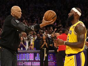NBA Commissioner Adam Silver looks on as Kareem Abdul-Jabbar ceremoniously hands LeBron James #6 of the Los Angeles Lakers the ball after James passed Abdul-Jabbar to become the NBA's all-time leading scorer, surpassing Abdul-Jabbar's career total of 38,387 points against the Oklahoma City Thunder at Crypto.com Arena on February 07, 2023 in Los Angeles, California. (Photo by Harry How / GETTY IMAGES NORTH AMERICA / Getty Images via AFP)