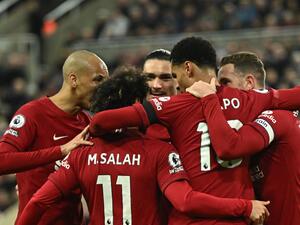 Liverpool's Dutch striker Cody Gakpo (C) celebrates after scoring his team second goal during the English Premier League football match between Newcastle United and Liverpool at St James' Park in Newcastle-upon-Tyne, north east England on February 18, 2023. (Photo by Oli SCARFF / AFP)