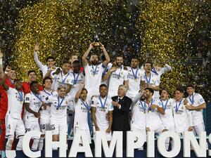 Real Madrid's players celebrate with the trophy at the end of the FIFA Club World Cup final football match between Spain's Real Madrid and Saudi Arabia's Al-Hilal at the Prince Moulay Abdellah Stadium in Rabat on February 11, 2023. Real Madrid lifted the Club World Cup for a record fifth time with a pulsating 5-3 win over Al-Hilal. (Photo by Khaled DESOUKI / AFP)