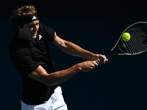 Germany's Alexander Zverev hits a return against Michael Mmoh of the US during their men's singles match on day four of the Australian Open tennis tournament in Melbourne on January 19, 2023. (Photo by Manan VATSYAYANA / AFP)