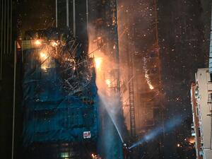 A fire burns at a high-rise building under construction in the Tsim Sha Tsui district in Hong Kong on March 3, 2023. (Photo by Peter PARKS / AFP) Hong Kong