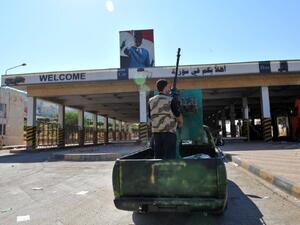 AFP Photo: A Syrian rebel stands on a vehicle at the Bab al-Hawa border post with Turkey on July 20, 2012 in Bab al-Hawa. Syrians claim Turkish border forces beat them