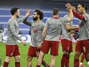 Liverpool's Egyptian forward Mohamed Salah (2L) and teammates slap hands prior to the UEFA Champions League last 16 second leg football match between Real Madrid CF and Liverpool FC at the Santiago Bernabeu stadium in Madrid on March 15, 2023. (Photo by JAVIER SORIANO / AFP)