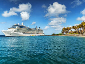 In a federal lawsuit filed on April 19 against Celebrity Cruises, a man's family accuses the cruise line of storing his dead body in a drink cooler after the ship's morgue malfunctioned. WILLEMSTAD, CURACAO - APRIL 10, 2018: View from infinity pool with beach on Cruise ship Celebrity Eclipse docked at port Willemstad.