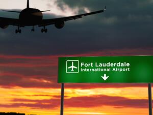 Airplanes sat at Fort Lauderdale-Hollywood International Airport Thursday after heavy rain caused the airport to shut down. Airplane flying over sign for Fort Lauderdale-Hollywood International Airport