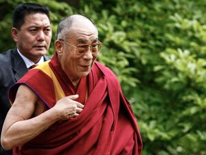 The head of the Tibetan government-in-exile has defended the Dalai Lama over a video in which the spiritual leader kisses a child on the lips and then asks him to “suck my tongue.” The Dalai Lama during a visit in London
