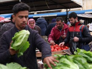 This picture taken on April 12, 2023, shows Syrians shopping at a market ahead of Iftar in Syria's rebel-held northwestern city of Idlib, during the Muslim holy month of Ramadan. (Photo by OMAR HAJ KADOUR / AFP) Syrians
