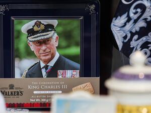 A tin of biscuits with the portrait of Britain's King Charles III is displayed in the front window of a shop, in Windsor, on May 2, 2023, ahead of the coronation ceremony of Charles III and his wife, Camilla, as King and Queen of the United Kingdom and Commonwealth Realm nations, on May 6, 2023. (Photo by Adrian DENNIS / AFP) King Charles