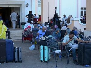 People wait with their luggage at Port Sudan on May 3, 2023 ahead of their evacuation by sea amid ongoing deadly clashes between rival generals' forces.  (Photo by AFP) Nigerians flee war in Sudan