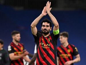 Manchester City's German midfielder Ilkay Gundogan applauds at the end of the UEFA Champions League semi-final first leg football match between Real Madrid CF and Manchester City at the Santiago Bernabeu stadium in Madrid on May 9, 2023. (Photo by JAVIER SORIANO / AFP)