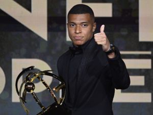 Paris Saint-Germain's French forward Kylian Mbappe thumbs up after receiving the Best Ligue 1 Player award during the 31th edition of the UNFP (French National Professional Football players Union) trophy ceremony, in Paris May 28, 2023. (Photo by Bertrand GUAY / AFP)