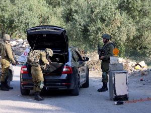 Israeli soldiers inspect a car at a checkpoint at the entrance of the Palestinian village of Orif, south of Nablus in the northern West Bank, on June 22, 2023, following an incursion by Israeli forces into the village. (Photo by Jaafar ASHTIYEH / AFP) Israeli Army