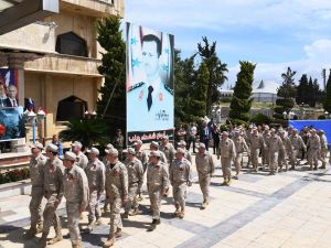 Russian soldiers parade in front of a poster of Syrian president Bashar al-Asad during a ceremony marking Soviet victory over Nazi Germany in WW II, in Aleppo's Saadallah al-Jabiri square in northern Syria on May 9, 2018. (Photo by GEORGE OURFALIAN / AFP) RELATED CONTENT Syria