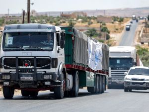 Trucks move in a United Nations aid convoy en route to Syria's rebel-held northwestern city of Idlib on June 23, 2023. (Photo by OMAR HAJ KADOUR / AFP) Syria