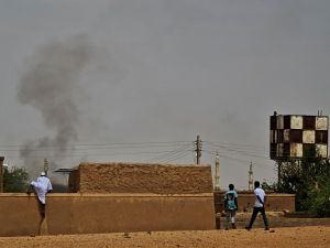 People flee as smoke billows on the first day of the Eid al-Adha Muslim holiday in Wad Hamid, about 100 kilometres north of Sudan's capital. (Photo by AFP) Sudan