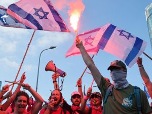 Demonstrators use flares as they stage a 'day of resistance' to protest the Israeli government's judicial overhaul bill, in Tel Aviv on July 18, 2023. (Photo by JACK GUEZ / AFP) Israeli Protestors