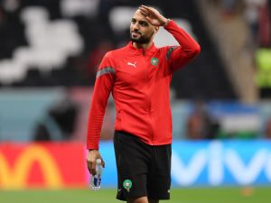Morocco's midfielder #04 Sofyan Amrabat greets fans ahead of the Qatar 2022 World Cup semi-final football match between France and Morocco at the Al-Bayt Stadium in Al Khor, north of Doha on December 14, 2022. (Photo by KARIM JAAFAR / AFP)