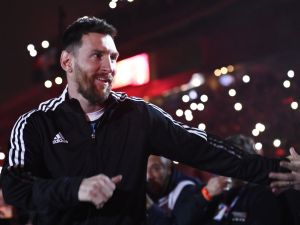 Argentine football player Lionel Messi greets fans during his entrance to the field before the start of Maximiliano Rodriguez's farewell match at the Marcelo Bielsa stadium in Rosario, Argentina on January 24, 2023. (Photo by STRINGER / AFP)
