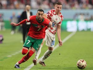 Morocco's midfielder #07 Hakim Ziyech (L) and Croatia's forward #18 Mislav Orsic fight for the ball during the Qatar 2022 World Cup third place play-off football match between Croatia and Morocco at Khalifa International Stadium in Doha on December 17, 2022. (Photo by KARIM JAAFAR / AFP)