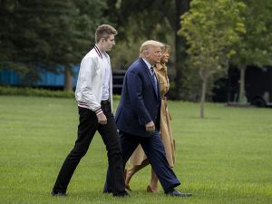 Barron Trump, US President Donald Trump and First lady Melania Trump walk on the South Lawn of the White House on August 16, 2020 in Washington, DC. Robert Trump, 71, the younger brother of the president, died Saturday in Manhattan. Tasos Katopodis/Getty Images/AFP Barron Trump