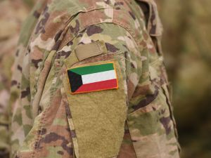 Kuwait flag on soldiers arm (collage)