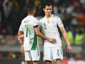 Algeria's forward Riyad Mahrez (L) and Algeria's defender Aissa Mandi (R) react after Ivory Coast won the Group E Africa Cup of Nations (CAN) 2021 football match between Ivory Coast and Algeria at Stade de Japoma in Douala on January 20, 2022. (Photo by CHARLY TRIBALLEAU / AFP)