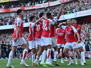 Arsenal's Brazilian striker #09 Gabriel Jesus celebrates with teammates after scoring their third goal during the English Premier League football match between Arsenal and Manchester United at the Emirates Stadium in London on September 3, 2023. (Photo by Glyn KIRK / AFP)