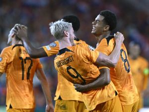 Netherlands' forward #08 Cody Gakpo (R) is congratulated by Netherlands' forward #09 Wout Weghorst (C) after scoring the Netherlands' second goal during the UEFA Euro 2024 football tournament group B qualification football match between the Netherlands and Greece at the Philips Stadium, in Eindhoven, on September 7, 2023. (Photo by JOHN THYS / AFP)