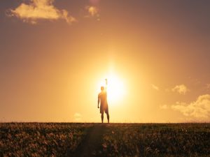 Strong determined man putting fist up to the sky. Mental and physical strength concept.