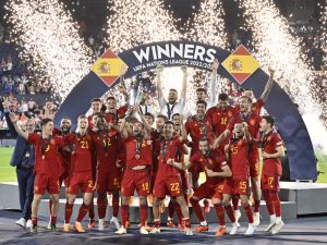 Spain's players celebrate on the podium with the UEFA Nations League cup after winning the penalty shootouts and the UEFA Nations League final football match between Croatia and Spain at the De Kuip Stadium in Rotterdam on June 18, 2023. (Photo by JOHN THYS / AFP)