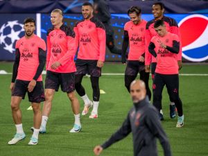 Manchester City's player (L-R) Portuguese defender #03 Ruben Dias, Norwegian striker #09 Erling Haaland, English defender #02 Kyle Walker, English midfielder #10 Jack Grealish, Swiss defender #25 Manuel Akanji and English midfielder #47 Phil Foden walk behind Spanish manager Pep Guardiola (Front) during a training session on the eve of the UEFA Champions League Group G football match between Young Boys and Manchester City, at Wankdorf Stadium in Bern, on October 24, 2023. (Photo by Fabrice COFFRINI / AFP)