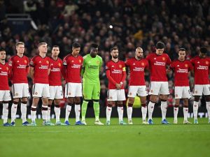 Manchester United's players observe a minute of silence in tribute of late Manchester United player Bobby Charlton who died at the age of 86, last weekend, ahead of the UEFA Champions League Group A football match between Manchester United and FC Copenhagen at Old Trafford, in Manchester, north-west England, on October 24, 2023. (Photo by Paul ELLIS / AFP)