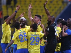 Nassr's Portuguese forward #07 Cristiano Ronaldo (C) celebrates with teammates after scoring their second goal during the Saudi Pro League football match between Al-Nassr and Damac at the King Saud University Stadium in Riyadh on October 21, 2023. (Photo by Fayez NURELDINE / AFP)
