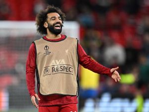 Liverpool's Egyptian striker #11 Mohamed Salah smiles as he warms up ahead of the UEFA Europa League group E football match between Liverpool and Royale Union Saint-Gilloise at Anfield in Liverpool, north west England on October 5, 2023. (Photo by Oli SCARFF / AFP)