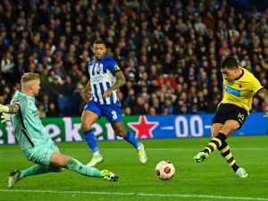 AEK's Argentinian forward #14 Ezequiel Ponce shoots and scores his team third goal during the UEFA Europa League Group B football match between Brighton and Hove Albion and AEK Athens at the American Express Community Stadium in Brighton, southern England on September 21, 2023. (Photo by Glyn KIRK / AFP)