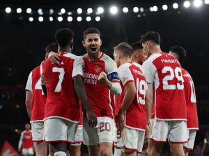 Arsenal's Italian midfielder #20 Jorginho (C) celebrates with teammates after their opening goal during the UEFA Champions League Group B football match between Arsenal and Sevilla at the Emirates Stadium in north London on November 8, 2023. (Photo by Adrian DENNIS / AFP)