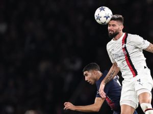 AC Milan's French forward #09 Olivier Giroud heads the ball next to Paris Saint-Germain's Moroccan defender #02 Achraf Hakimi during the UEFA Champions League Group F football match between Paris Saint-Germain (PSG) and AC Milan at the Parc de Princes in Paris on October 25, 2023. (Photo by FRANCK FIFE / AFP)
