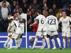 Real Madrid's Brazilian forward #11 Rodrygo (L) celebrates scoring his team's third goal during the UEFA Champions League group C football match between Real Madrid CF and SC Braga at the Santiago Bernabeu stadium in Madrid on November 8, 2023. (Photo by Pierre-Philippe MARCOU / AFP)