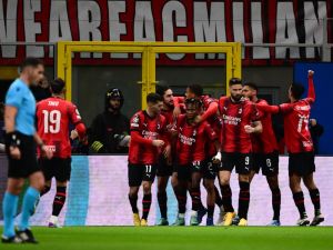 AC Milan's Nigerian midfielder #21 Samuel Chukwueze celebrates with teammates after scoring the team's first goal during the UEFA Champions League Group F football match between AC Milan and Borussia Dortmund at the San Siro stadium in Milan on November 28, 2023. (Photo by Marco BERTORELLO / AFP)