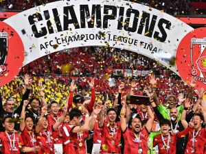 Urawa Red Diamonds players celebrate with the trophy after their victory against Al-Hilal in the second leg of the AFC Champions League final at Saitama Stadium in Saitama on May 6, 2023. (Photo by Philip FONG / AFP)