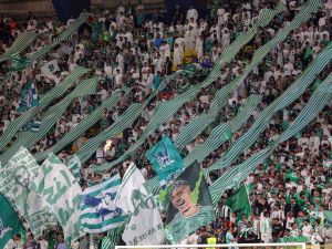 Ahli's supporters lift banners during the Saudi Pro League football match between Al-Nassr and Al-Ahli at the King Saud University Stadium in Riyadh, on September 22, 2023. (Photo by Fayez Nureldine / AFP)