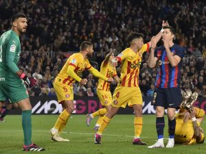 Barcelona's Polish forward Robert Lewandowski (2R) reacts to missing a chance to score during the Spanish league football match between FC Barcelona and Girona FC at the Camp Nou stadium in Barcelona on April 10, 2023. (Photo by Pau BARRENA / AFP)