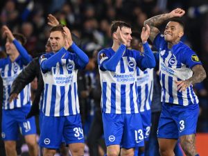 Brighton's players celebrate on the pitch after the UEFA Europa League Group B football match between Brighton and Hove Albion and Marseille at the American Express Community Stadium in Brighton, southern England on December 14, 2023. Brighton won the game 1-0 and top the Group. (Photo by Glyn KIRK / AFP)