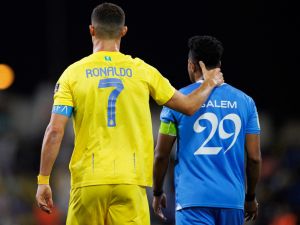 Nassr's Portuguese forward #07 Cristiano Ronaldo speaks with Hilal's Saudi midfielder #29 Salem al-Dawsari during the 2023 Arab Club Champions Cup final football match between Saudi Arabia's Al-Hilal and Al-Nassr at the King Fahd Stadium in Taif on August 12, 2023. (Photo by AFP)