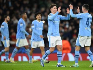 Manchester City's Argentinian striker #19 Julian Alvarez (2R) celebrates scoring the team's third goal with Manchester City's English midfielder #47 Phil Foden during the UEFA Champions League Group G football match between Manchester City and RG Leipzig at the Etihad Stadium, in Manchester, north west England, on November 28, 2023. (Photo by Oli SCARFF / AFP)